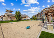 Thumbnail 19 of 19 - Sand Volleyball area with seating at Auberge of Burleson apartments in Burleson TX.
