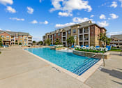 Thumbnail 2 of 19 - Resort-style swimming pool at Auberge of Burleson luxury apartments in Burleson TX.