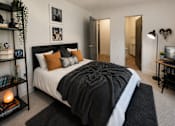 Thumbnail 19 of 23 - A bedroom with a large bed and a guitar on the wall.