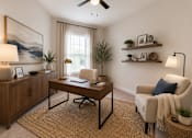 Thumbnail 20 of 23 - Flexible room staged as a home office with natural light at The Mill Old Town Apartments.