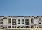 Thumbnail 5 of 16 - Modern apartment building exterior with covered parking at The Westerly Apartments, Midlothian, 76065