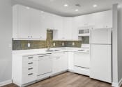 Thumbnail 12 of 21 - Kitchen with White Cabinets at Sleek Lofts