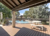 Thumbnail 15 of 21 - The Community Outdoor Deck and Swimming Pool at Greentree Village Apartments