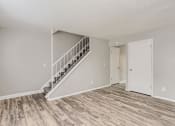 Thumbnail 10 of 17 - A living Room and staircase at Alder Square Townhomes Apartments