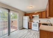 Thumbnail 5 of 17 - A kitchen with a Sliding Glass Door leading to patio area