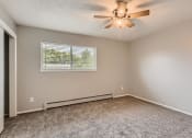 Thumbnail 11 of 17 - A bedroom with a window and floor heater at Alder Square Townhomes Apartments