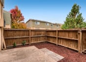 Thumbnail 7 of 17 - A standard fenced in patio area at Alder Square Townhomes Apartments
