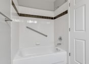 Thumbnail 24 of 38 - A Bathroom Tub/Shower at The Buttes Apartments, Loveland, CO