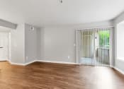 Thumbnail 10 of 38 - A Living Room with a view of the Patio/Balcony at The Buttes Apartments, Loveland Colorado