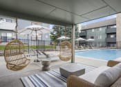 Thumbnail 24 of 29 - The Community Pool and Lounge Area at Hilltop View Apartments