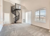 Thumbnail 3 of 20 - A Living Room with a Spiral Staircase at Fox Run Lofts Apartments