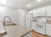 Thumbnail 12 of 38 - A Kitchen at The Buttes Apartments, Loveland, CO 80537