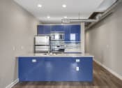 Thumbnail 17 of 21 - Our Apartment Kitchen with Blue Cabinets at Sleek Lofts