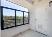 Thumbnail 38 of 46 - the living room has a large window and a door to the balcony at Metro Gateway, Riverside, CA