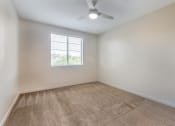 Thumbnail 34 of 46 - an empty room with a ceiling fan and a window at Metro Gateway, Riverside, CA