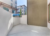 Thumbnail 37 of 46 - a patio with a wall and a door to a balcony at Metro Gateway, Riverside, CA, 92503