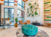 Thumbnail 11 of 46 - a living room with a turquoise ottoman in the center of it at Metro Gateway, California