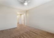 Thumbnail 33 of 46 - a living room with white walls and carpet and a ceiling fan at Metro Gateway, Riverside, 92503