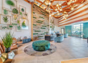 Thumbnail 12 of 46 - the lobby of a hotel with a reception area and plants on the wall at Metro Gateway, Riverside, CA