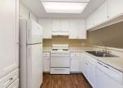 Thumbnail 11 of 22 - a kitchen with white appliances and white cabinets
