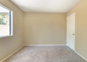Thumbnail 16 of 22 - an empty room with a door and a window