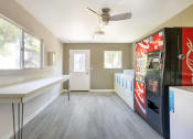 Thumbnail 8 of 22 - a kitchen with a coke refrigerator and a counter and a window