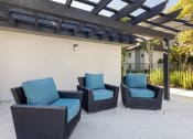 Thumbnail 5 of 22 - an outdoor patio with chairs and a pergola