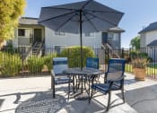 Thumbnail 6 of 22 - our patio has a table with chairs and an umbrella