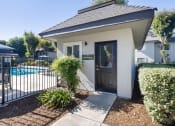 Thumbnail 9 of 22 - the front door of a house with a swimming pool