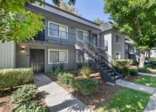 Thumbnail 19 of 22 - an apartment building with stairs and a sidewalk