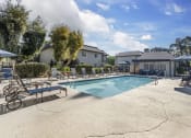 Thumbnail 1 of 22 - our apartments have a resort style pool with lounge chairs and umbrellas