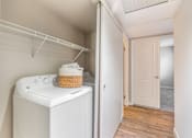 Thumbnail 15 of 22 - a washer and dryer in a laundry room with a door to a closet