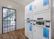 Thumbnail 10 of 29 - a row of white appliances in a room with a glass door