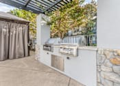 Thumbnail 6 of 30 - We offer two stainless steel barbecue grills on the side of a patio