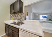 Thumbnail 14 of 29 - an empty kitchen with a sink and a window