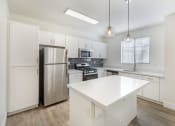 Thumbnail 20 of 45 - Experience the epitome of modern elegance at The Michael B apartments, where sleek white cabinetry meets state-of-the-art stainless steel appliances, setting the stage for gourmet culinary adventures.