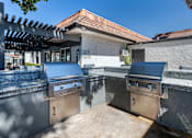 Thumbnail 10 of 28 - an outdoor kitchen with stainless steel appliances and granite counter tops at Sage Creek Apartment Homes, Simi Valley California