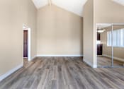 Thumbnail 16 of 28 - Welcome to Independence Plaza: Where chic meets space. Discover updated flooring, mirrored storage, and endless possibilities in this inviting living room.