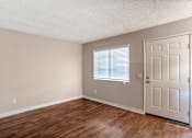 Thumbnail 9 of 19 - a bedroom with hardwood floors and a white door at Scripps Poway Villas, Poway, 92064