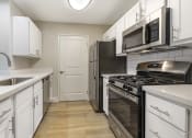 Thumbnail 20 of 29 - Featuring sleek stainless steel appliances, including a spacious refrigerator and a convenient dishwasher, these kitchens are designed for both cooking and entertaining.