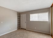 Thumbnail 11 of 19 - a bedroom with gray walls and a white door and window at Scripps Poway Villas, Poway