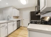 Thumbnail 21 of 29 - With ample counter space and stylish cabinetry, this kitchen is not only a chef's dream but also a warm, welcoming hub for your home.
