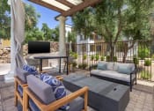 Thumbnail 7 of 42 - Enjoy our inviting patio furnished with comfy couches and a convenient table for your relaxation at Trevi Apartment Homes, Arizona, 85224