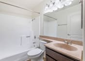 Thumbnail 19 of 28 - Step into luxury at Independence Plaza: where every bathroom is a retreat, complete with modern fixtures, a sleek sink, a cozy bath, and a mirror that reflects your impeccable taste.