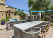 Thumbnail 8 of 42 - Poolside BBQ area at Trevi Apartment Homes, Chandler, Arizona