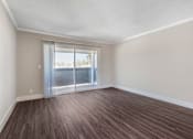 Thumbnail 19 of 28 - a bedroom with a sliding glass door and hardwood floors at Sage Creek Apartment Homes, Simi Valley, CA 93063