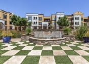 Thumbnail 10 of 42 - Experience serenity on our green checkered lawn, with a centerpiece fountain at Trevi Apartment Homes, Chandler, 85224