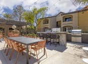 Thumbnail 8 of 29 - Featuring ample seating options near the grills on our pool deck, you can lounge in style while soaking up the sun or enjoying a refreshing dip in the pool.