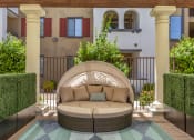 Thumbnail 5 of 42 - Enjoy our inviting patio, complete with a comfy couch and rug, perfect for unwinding outdoors at Trevi Apartment Homes, Chandler, AZ