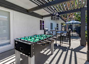 Thumbnail 5 of 28 - Covered area with foosball and sitting area.at Sage Creek Apartment Homes, Simi Valley, CA 